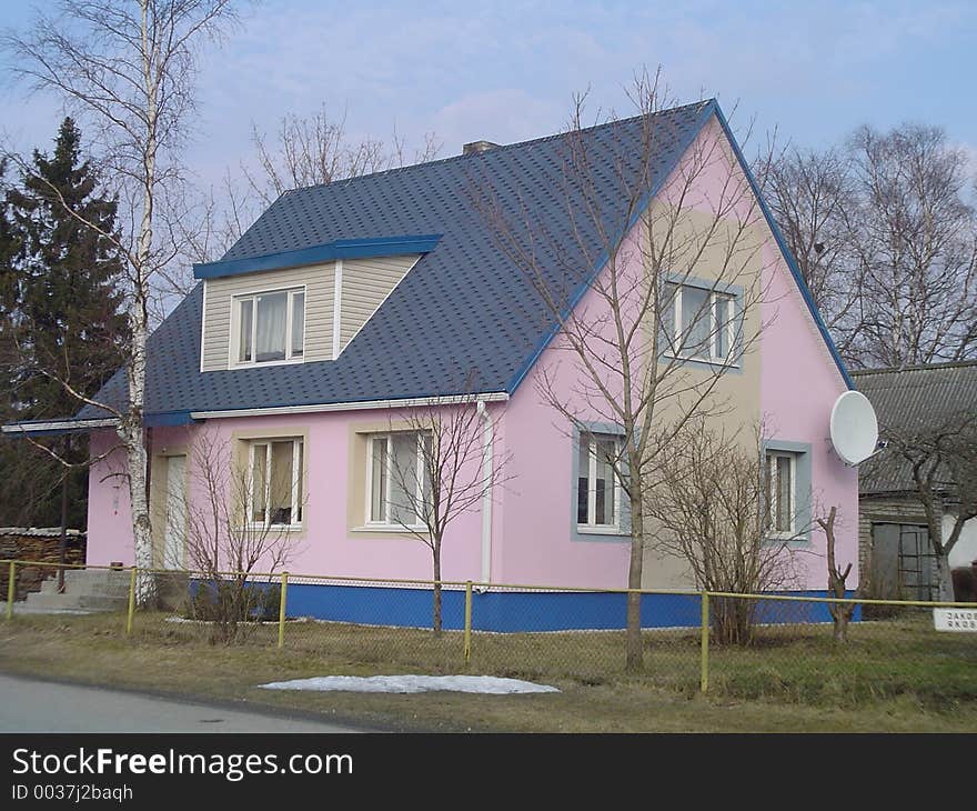 Colourful small home at the side of a city. Colourful small home at the side of a city