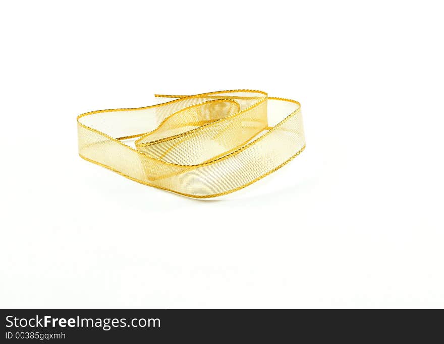 Gold wire mesh ribbon against a white background. Gold wire mesh ribbon against a white background.