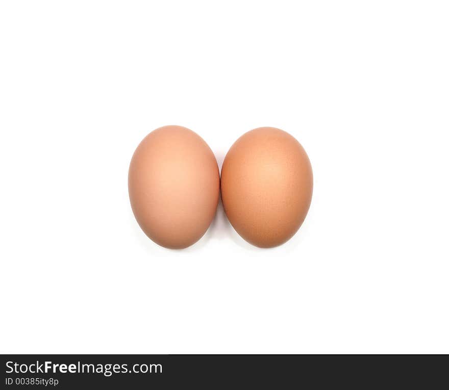 Two eggs next to each other against a white background. Two eggs next to each other against a white background.