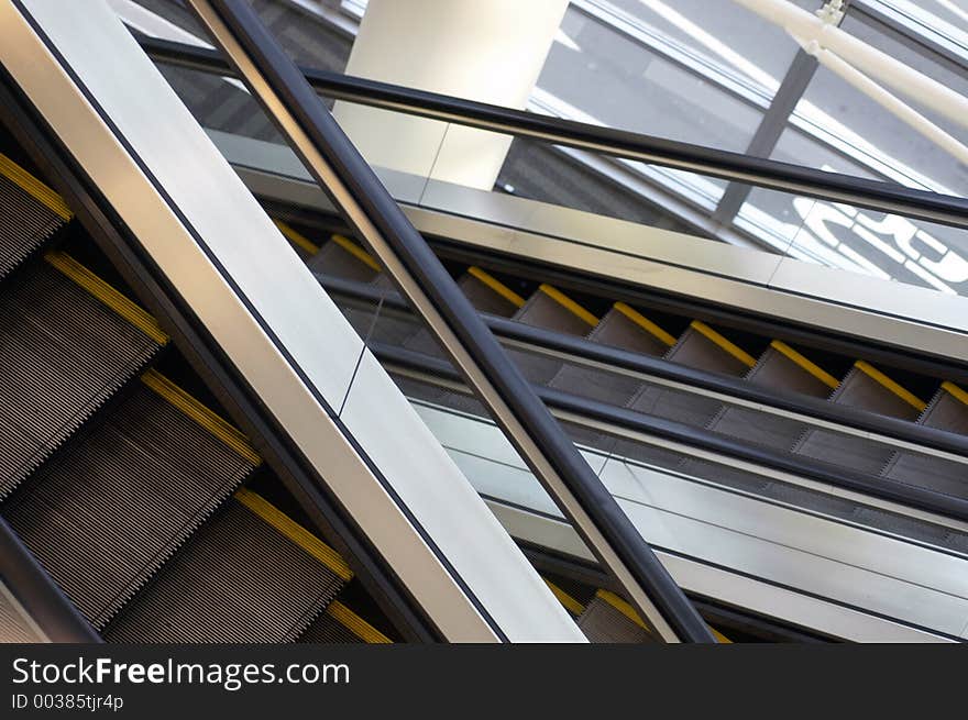 Two escalators cross on a diagonal. Two escalators cross on a diagonal