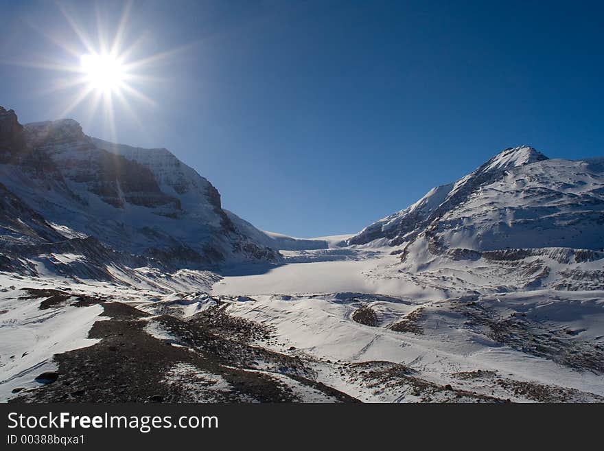 A bright sun breathes light on the Columbia Icefields in winter.