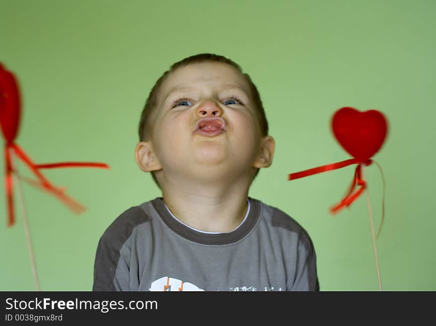 Boy has fun with valentine hearts. Boy has fun with valentine hearts