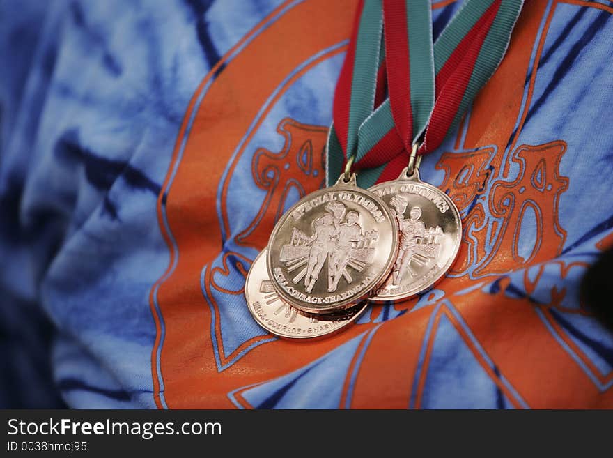 Winning gold medals on a blue and orange t-shirt. Winning gold medals on a blue and orange t-shirt