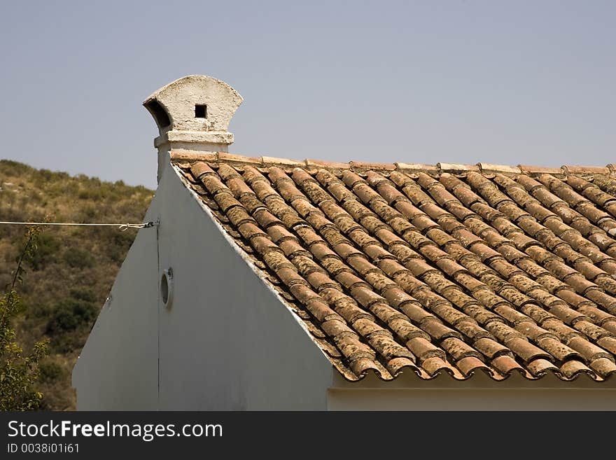 Section of a house showing spanish style shingles. Section of a house showing spanish style shingles