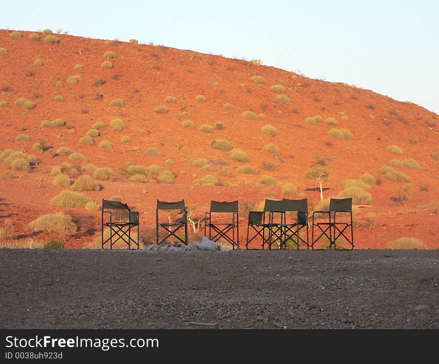 Campfire taken at sunset, empty chairs waiting for the evening when people chat and look at the stars. Campfire taken at sunset, empty chairs waiting for the evening when people chat and look at the stars