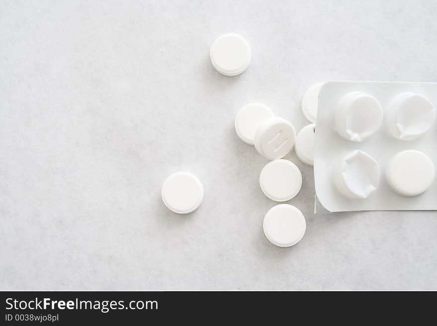 Closeup of tablets on white paper. Closeup of tablets on white paper