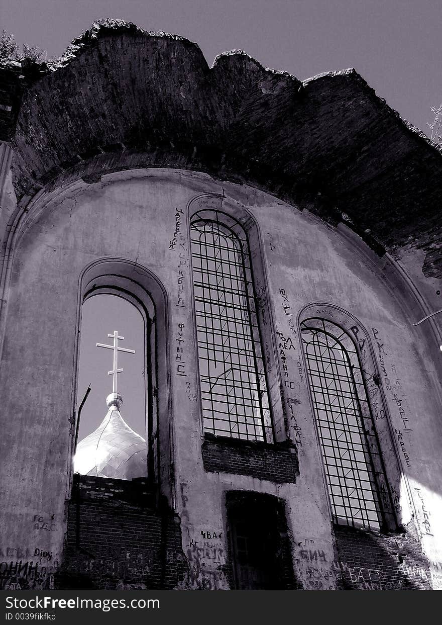 The ruinous church in Nizhni Nnovgorod region, Russia. In the nearest window-frame you can see a cupola of the new building. The ruinous church in Nizhni Nnovgorod region, Russia. In the nearest window-frame you can see a cupola of the new building.