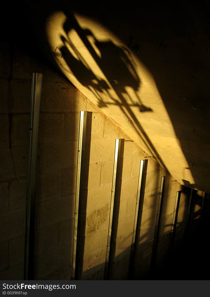 Original image of a long shadow at sunset at a construction site. Original image of a long shadow at sunset at a construction site.