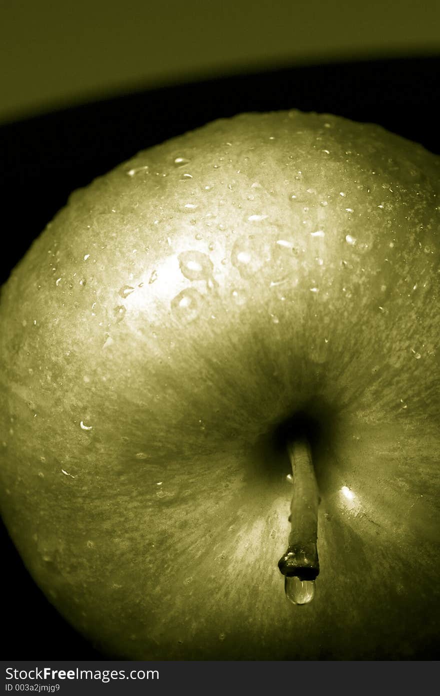 Green apples against a black background. Green apples against a black background