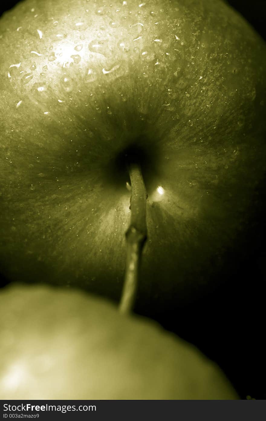 Green apples against a black background