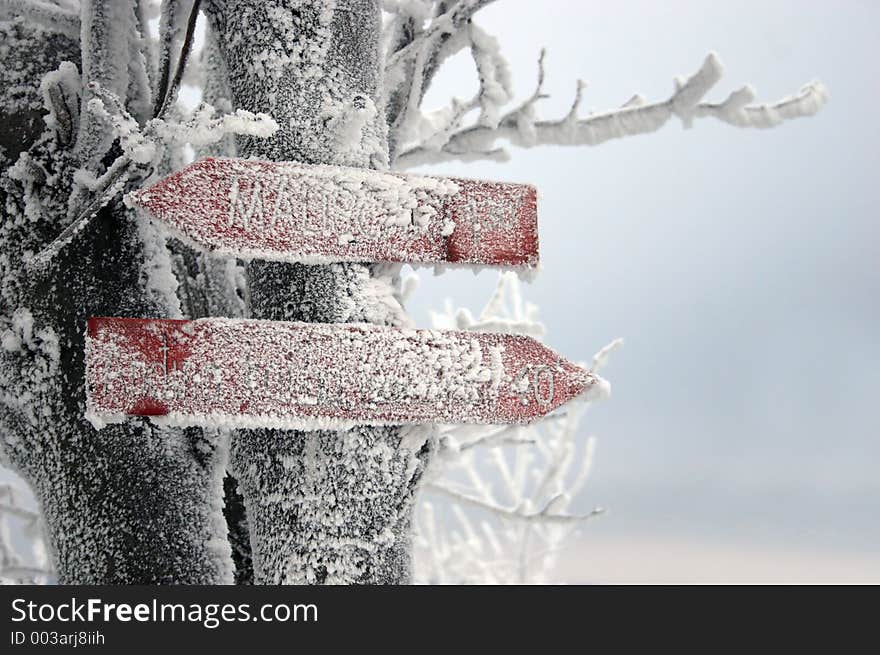 Frozen signpost with unreadable directions