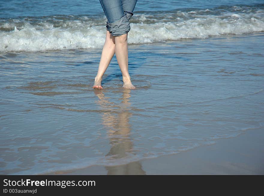 Crossed legs on the summer beach. Crossed legs on the summer beach.