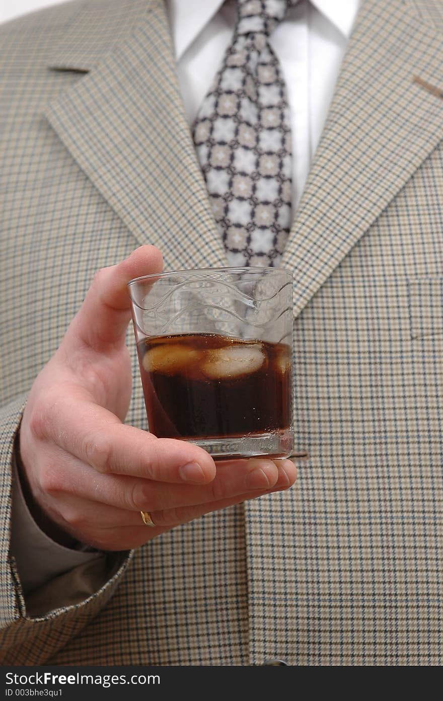 Businessman celebrating something with a glass of drink. Businessman celebrating something with a glass of drink