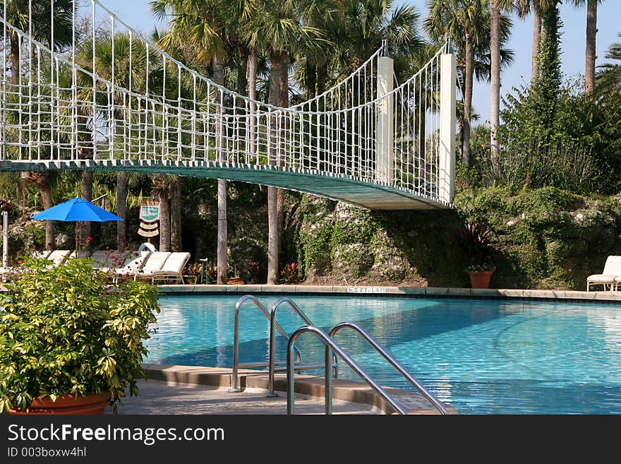 Resort pool with suspension bridge. Resort pool with suspension bridge