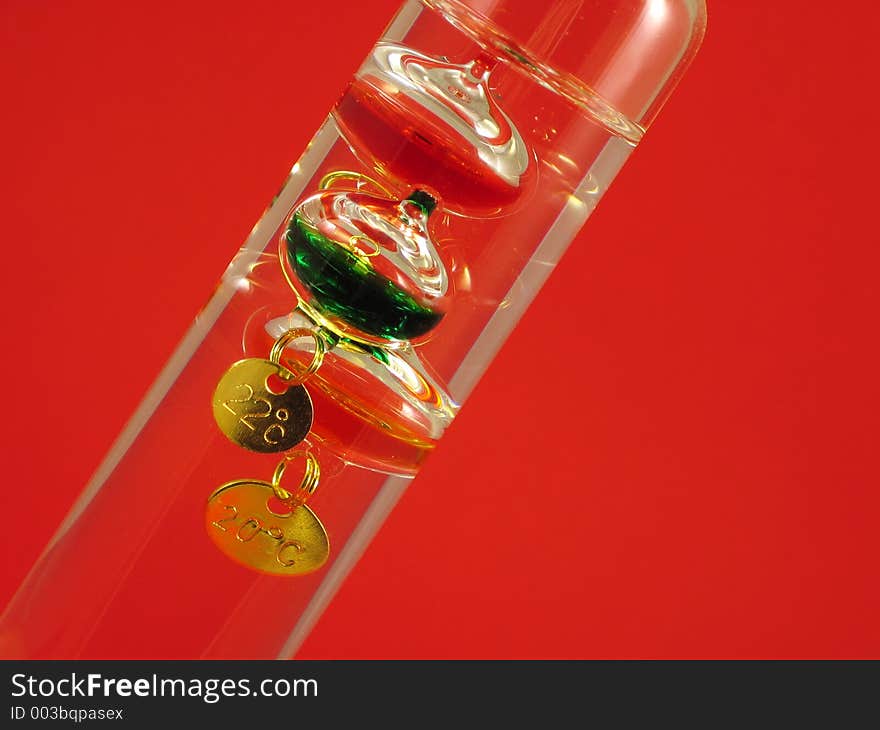 Galilean thermometer on re background in diagonal angle