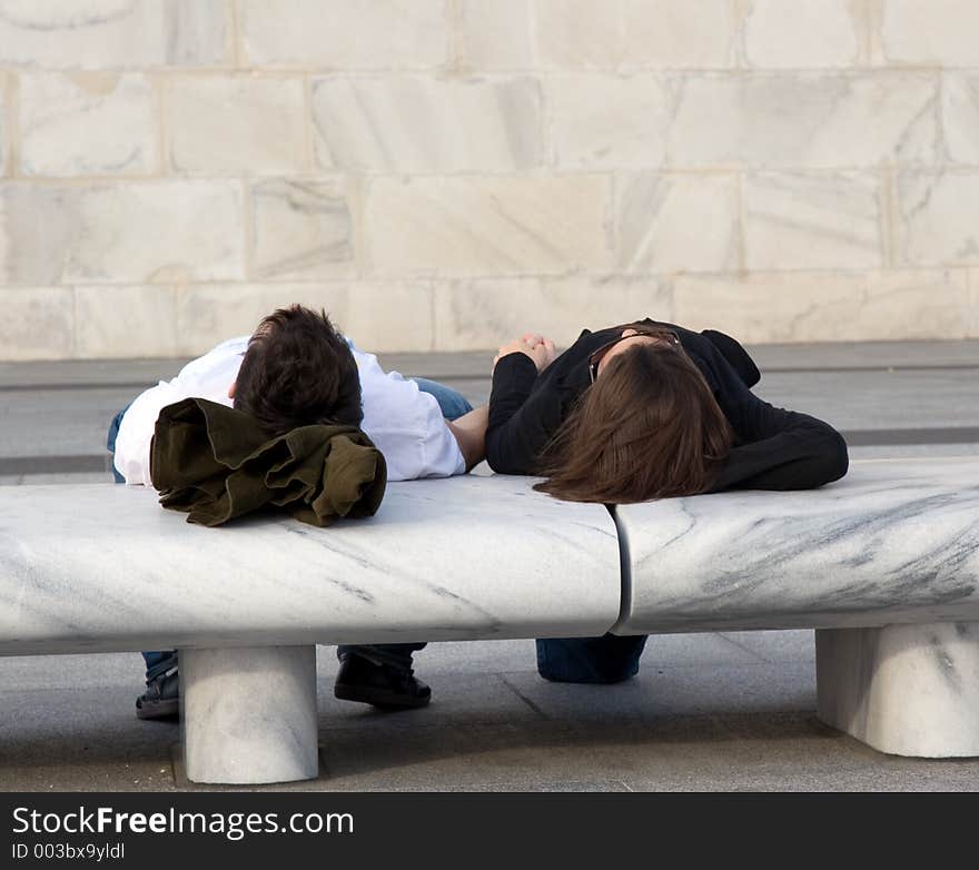 Couple Relaxing on Bench Holding Hands