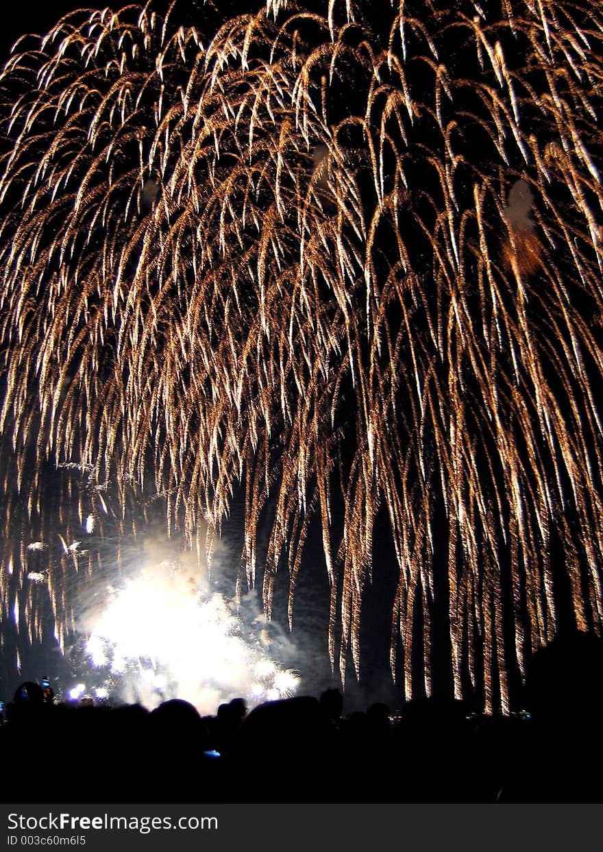 Fireworks display over a crowd. Fireworks display over a crowd