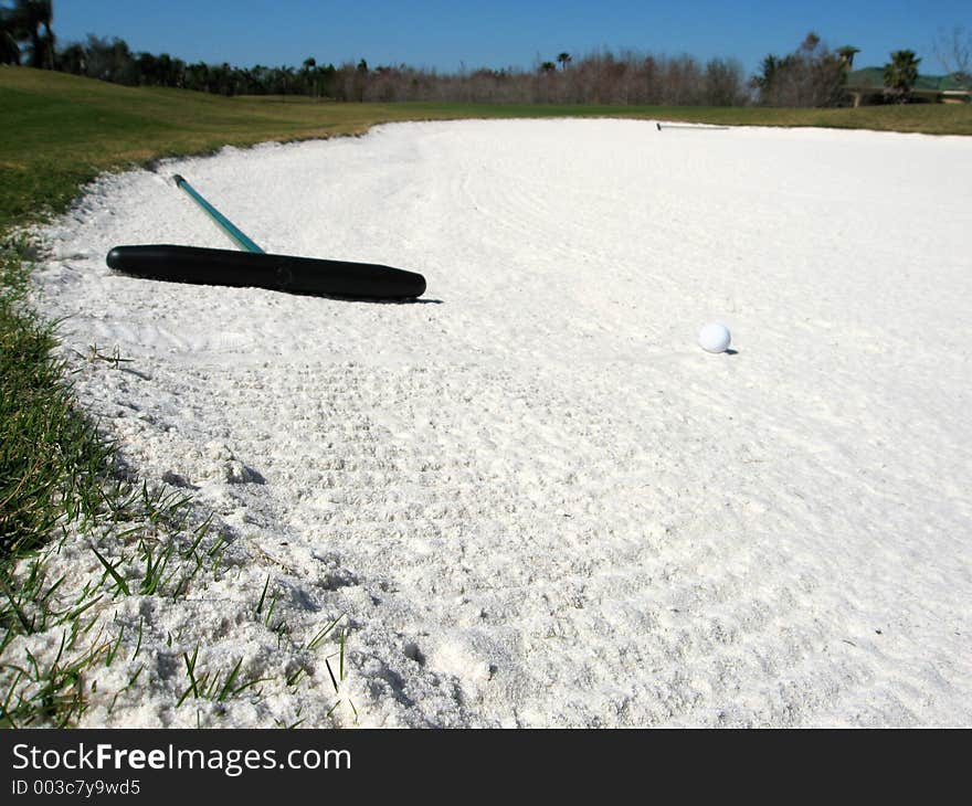 Orignal image of a golf ball in a sand bunker.