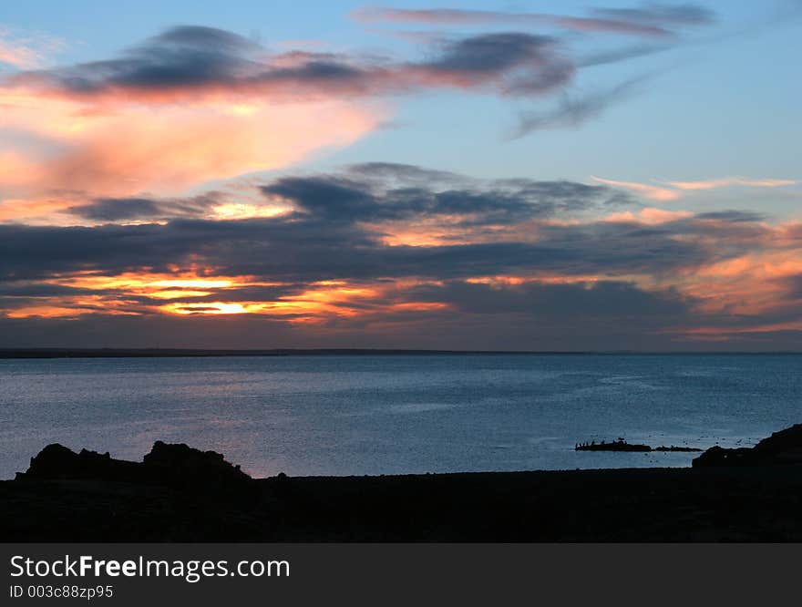 Sun setting by the seaside, intense colors. Sun setting by the seaside, intense colors