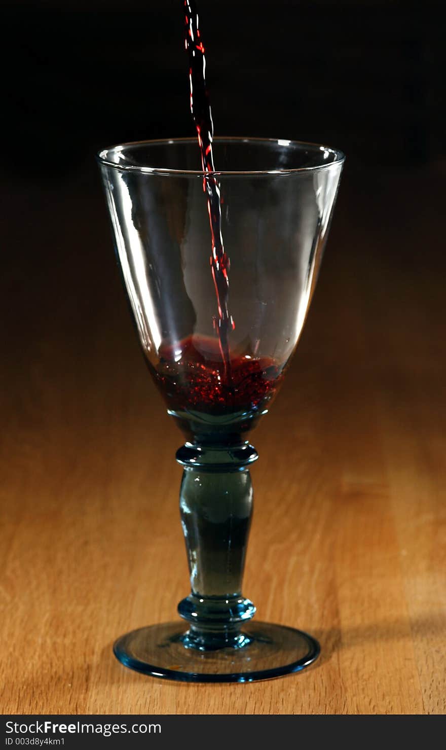 Red wine poured into a glass