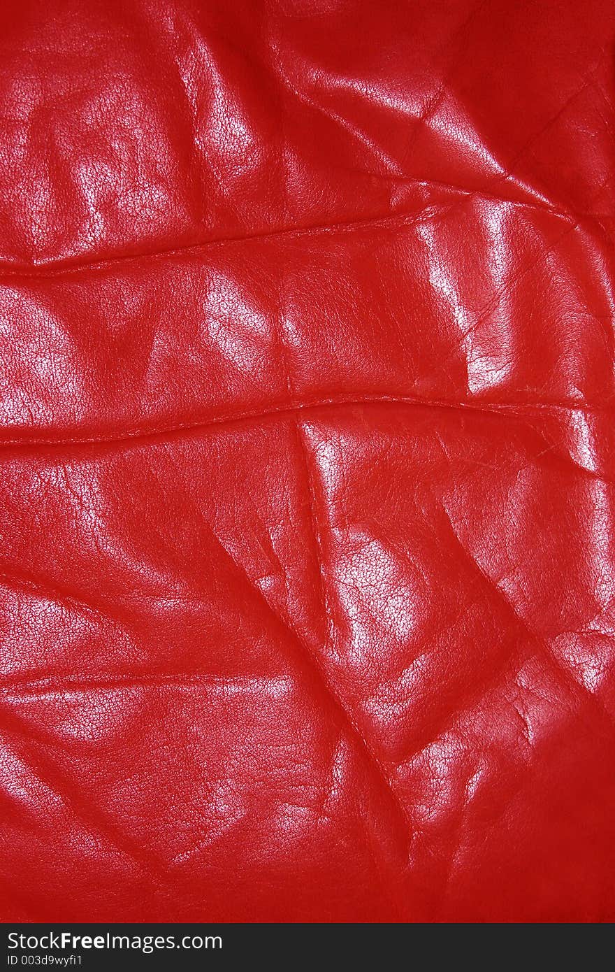 Wrinkled and worn red leather. Wrinkled and worn red leather