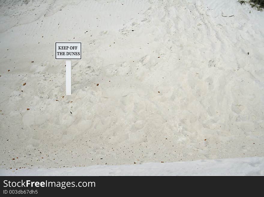 Sign on a dune saying Keep off the dunes horizontal with room for copy. Sign on a dune saying Keep off the dunes horizontal with room for copy