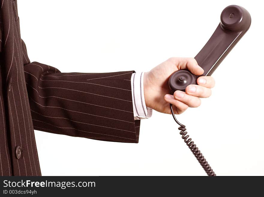 A businessman holding a telephone in his hand. A businessman holding a telephone in his hand