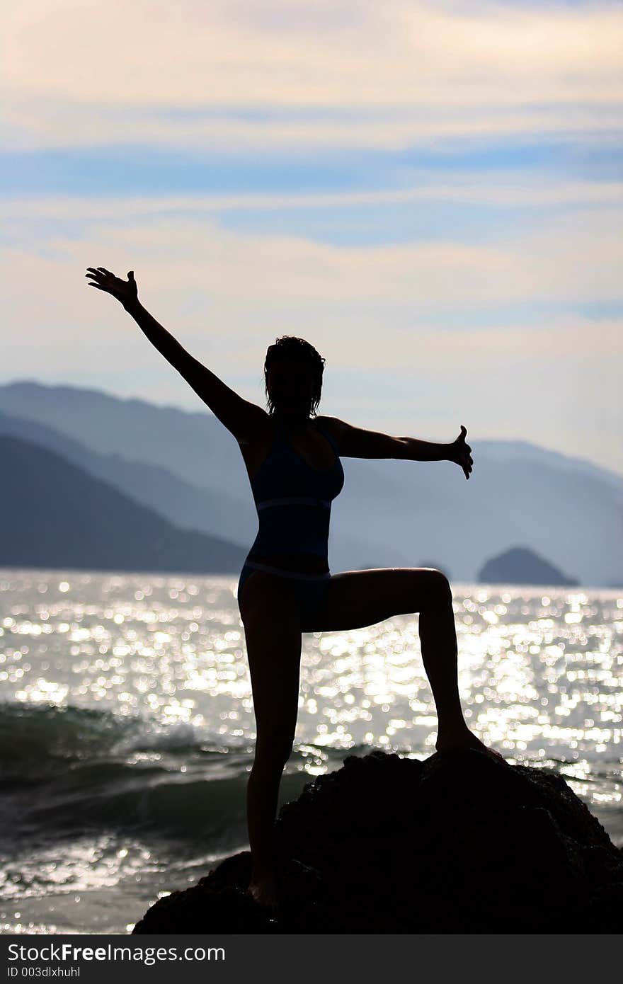 Woman silhouette at the beach