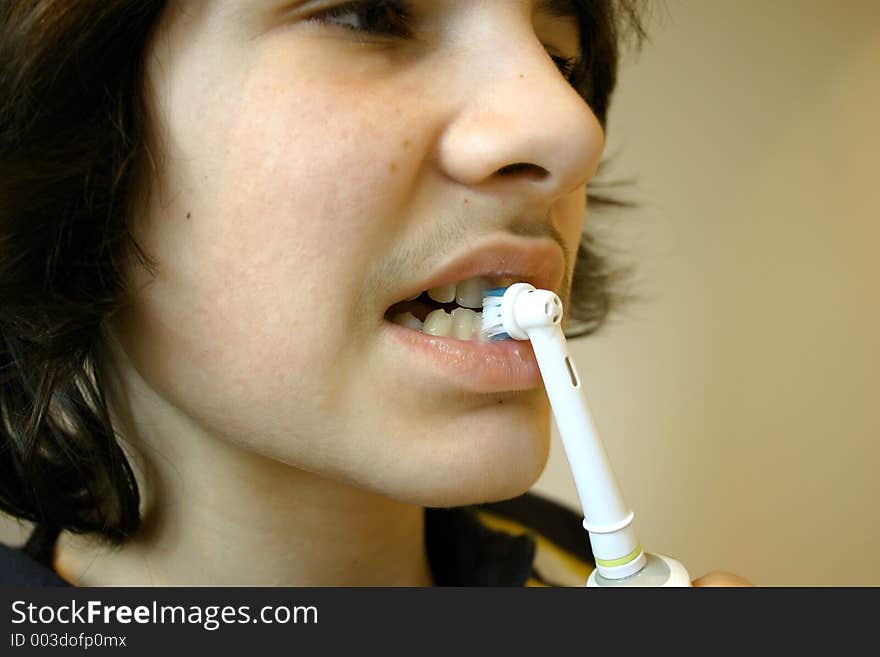 Young man brushing his teeth. Young man brushing his teeth