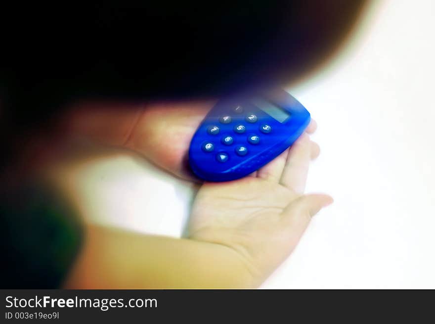 Child holding a bank token. Shot manipulated digitally, blur effects added. Child holding a bank token. Shot manipulated digitally, blur effects added.