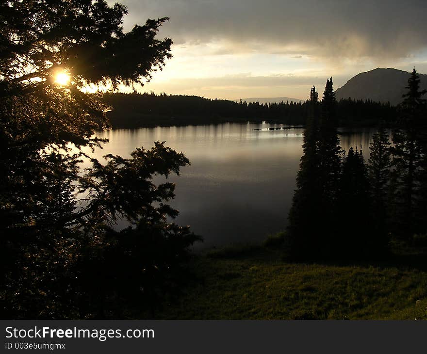 Very low dark Sunset on mountain lake: Lost Lake Colorado. Works great as wallpaper.