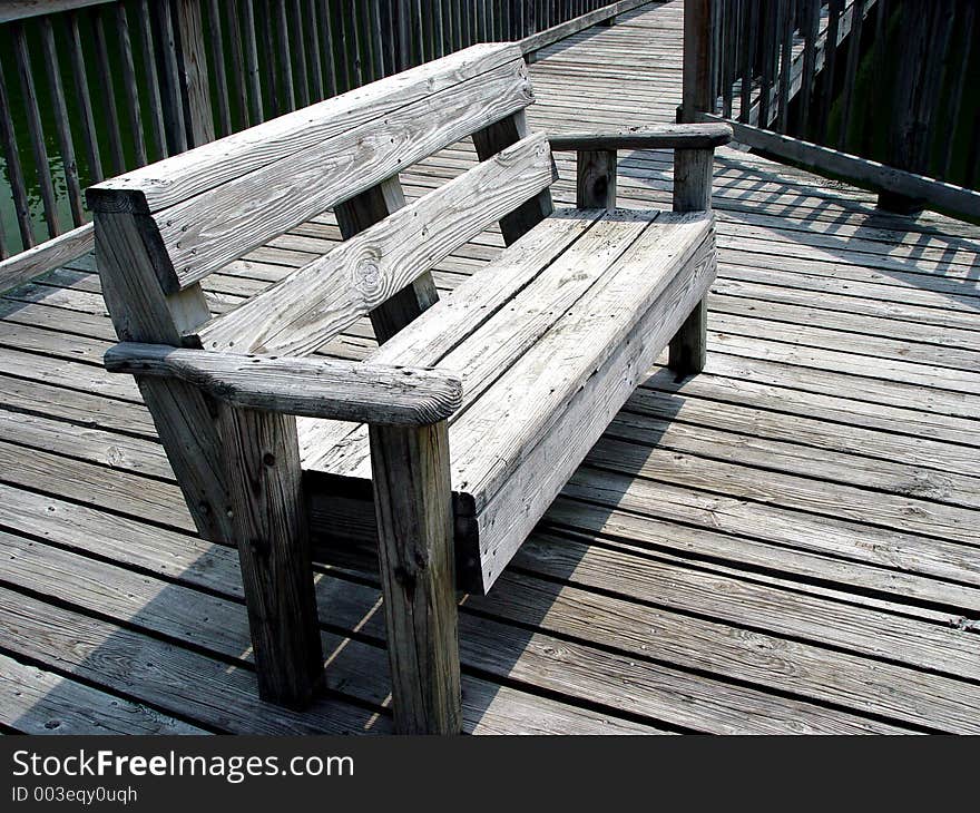 Wooden bench on a wooden boardwalk. Wooden bench on a wooden boardwalk