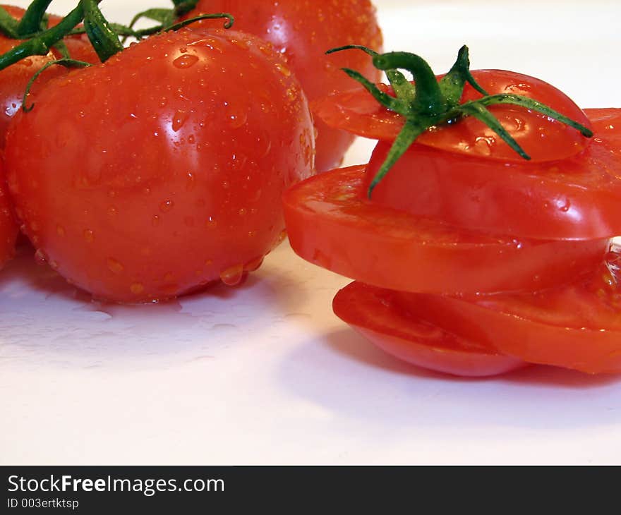 Shot of a few tomatoes over white.