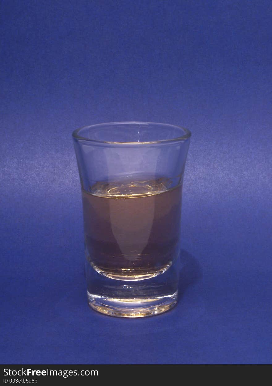 Ounce of rhum on blue background. Ounce of rhum on blue background