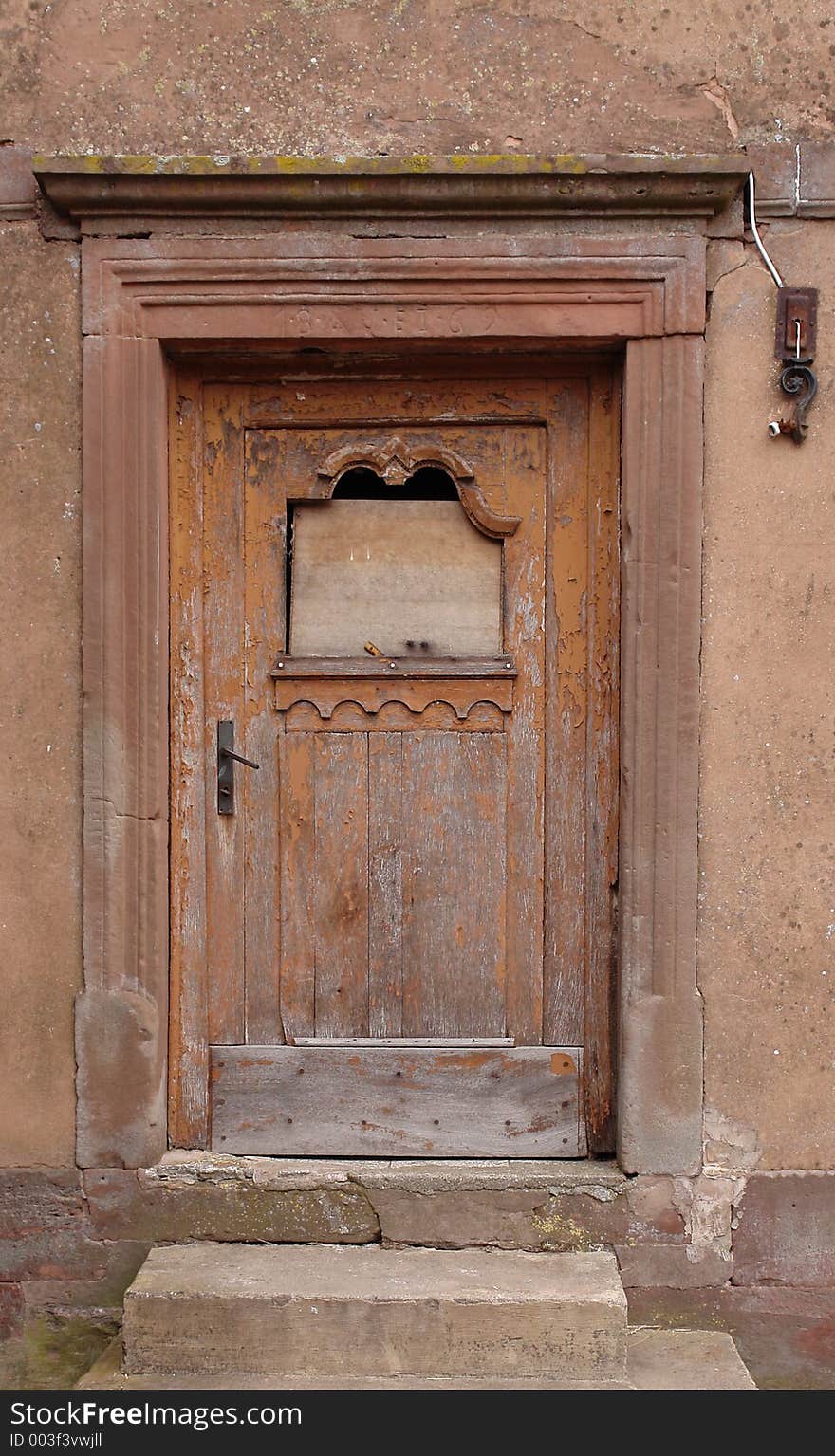 This is the boarded-up front door of a derelict house of 1869 in the Palatine area of Germany. This is the boarded-up front door of a derelict house of 1869 in the Palatine area of Germany