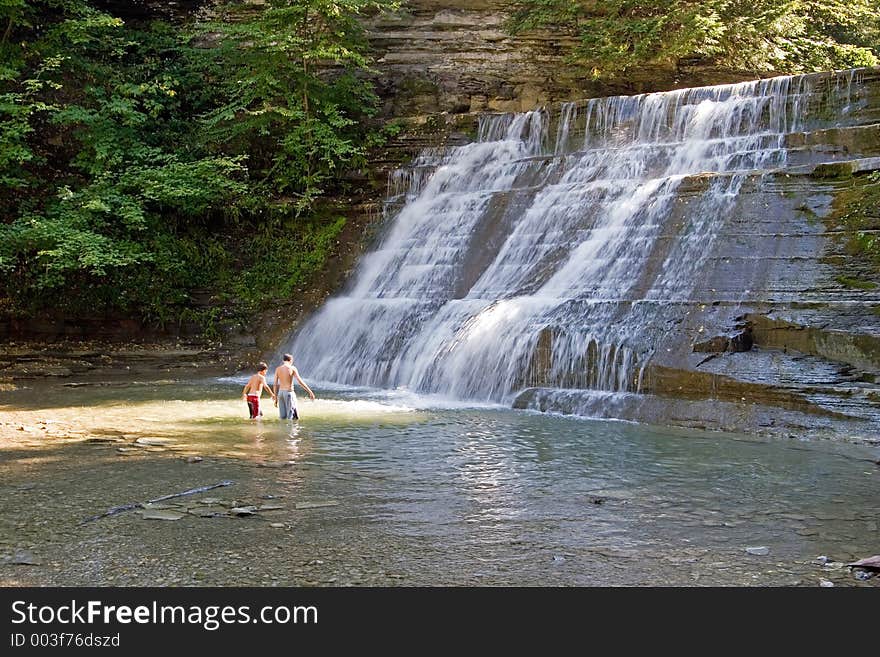 Boys playing in a waterfall in Stony Brook State Park, New York. Boys playing in a waterfall in Stony Brook State Park, New York