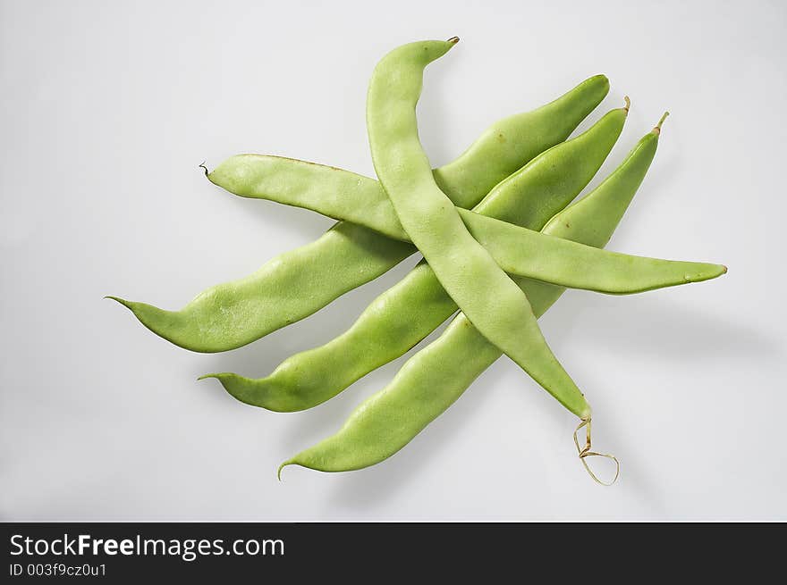 Five pole beans on white background - fuenf Fisolen auf weissem Hintergrund. Five pole beans on white background - fuenf Fisolen auf weissem Hintergrund