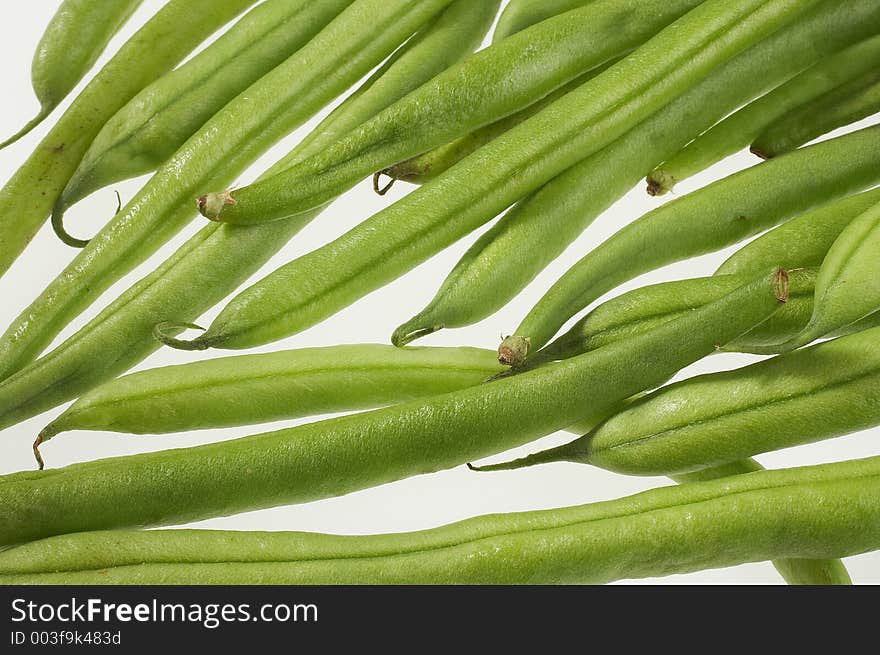 Many green beans on white background - viele gruene Bohnen auf weissem Hintergrund. Many green beans on white background - viele gruene Bohnen auf weissem Hintergrund