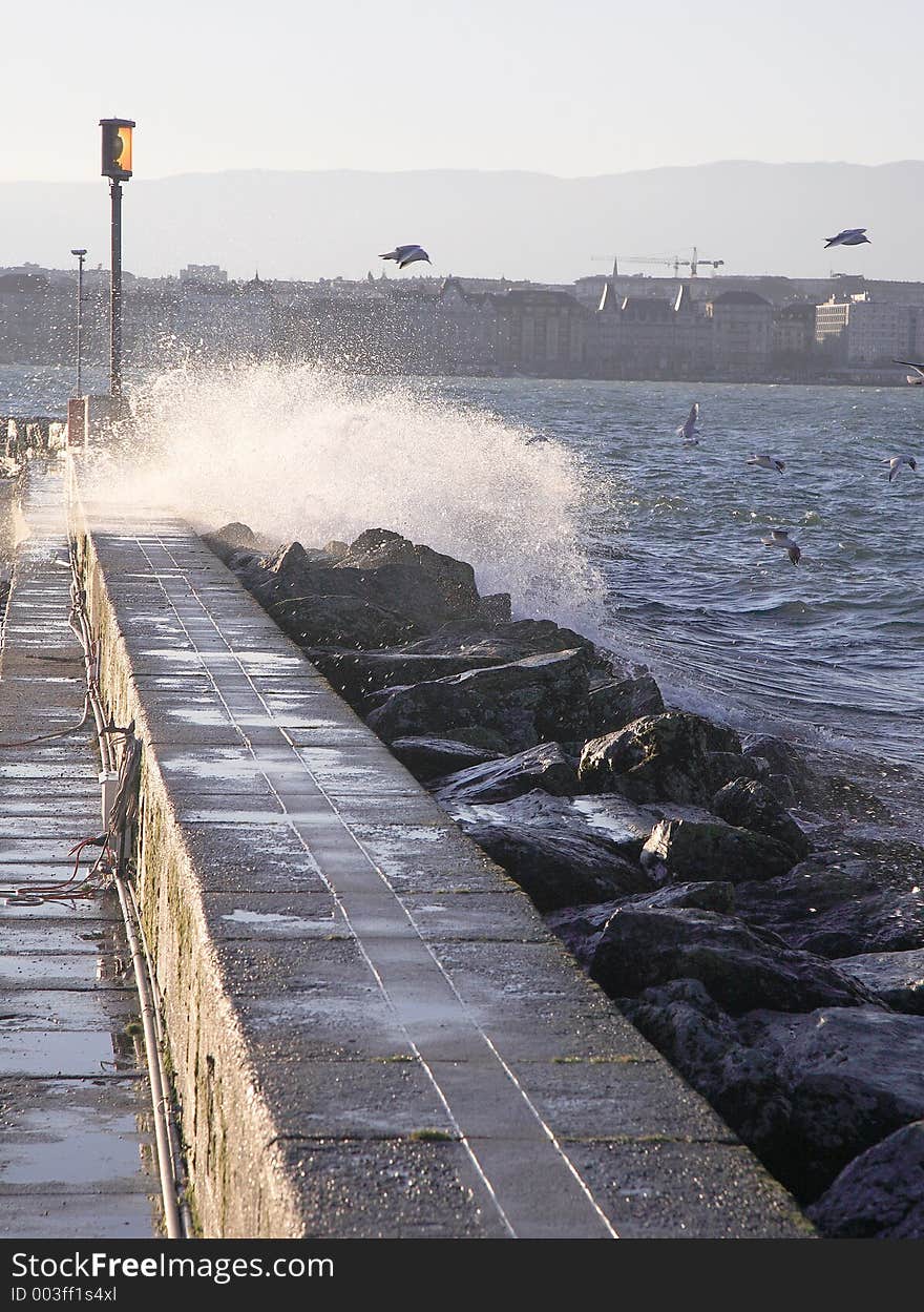 A furious wave scratch on the dam in geneva harbour. A furious wave scratch on the dam in geneva harbour