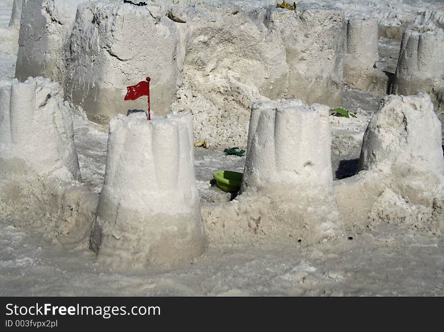 Sandcastle with red plastic flag. Sandcastle with red plastic flag