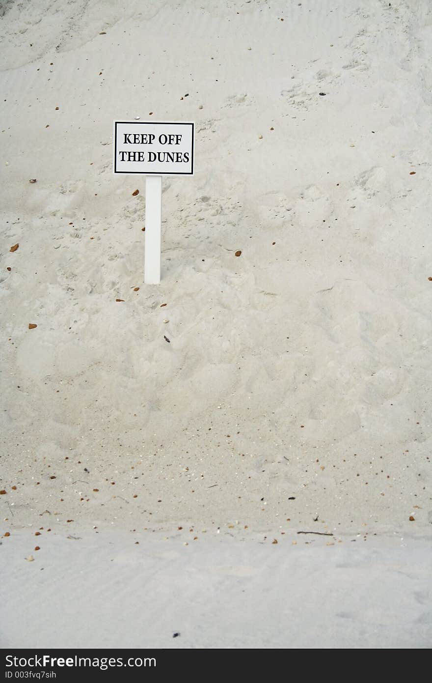 Sign on a dune saying Keep off the dunes vertical with room for copy. Sign on a dune saying Keep off the dunes vertical with room for copy