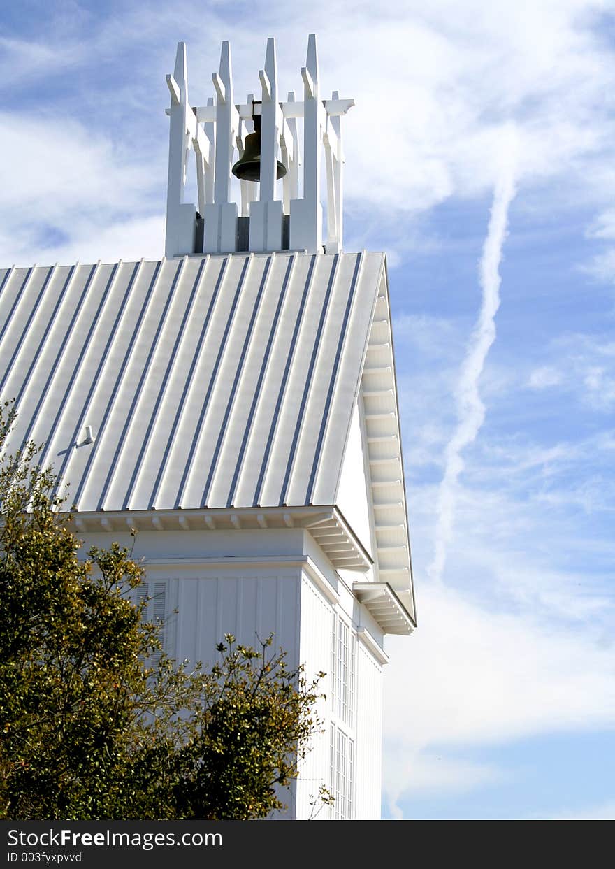 White church belfry against blue sky with clouds. White church belfry against blue sky with clouds