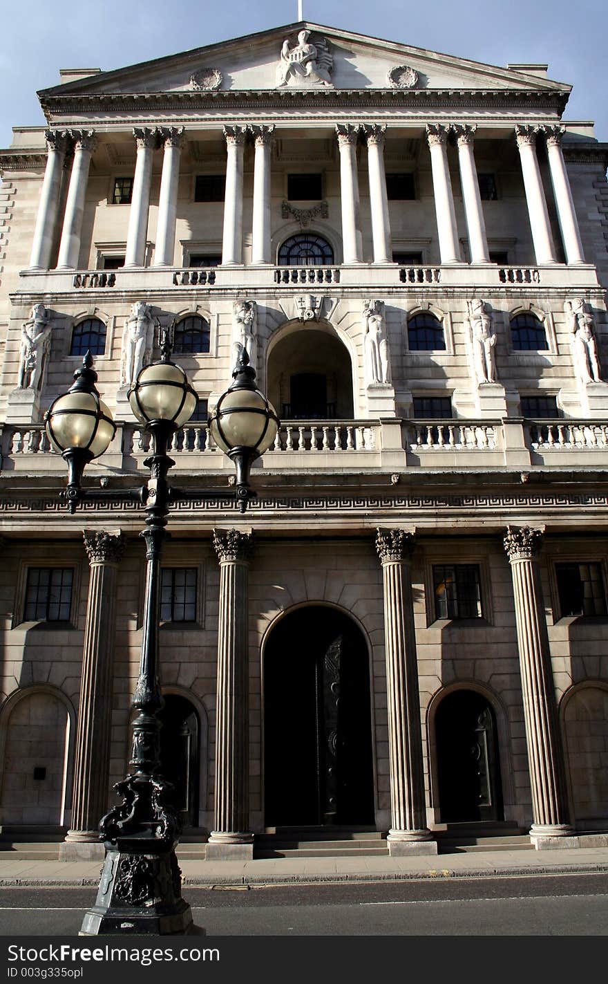 Image of a stone column building in central london with an old fashioned lampost in the foreground. Image of a stone column building in central london with an old fashioned lampost in the foreground