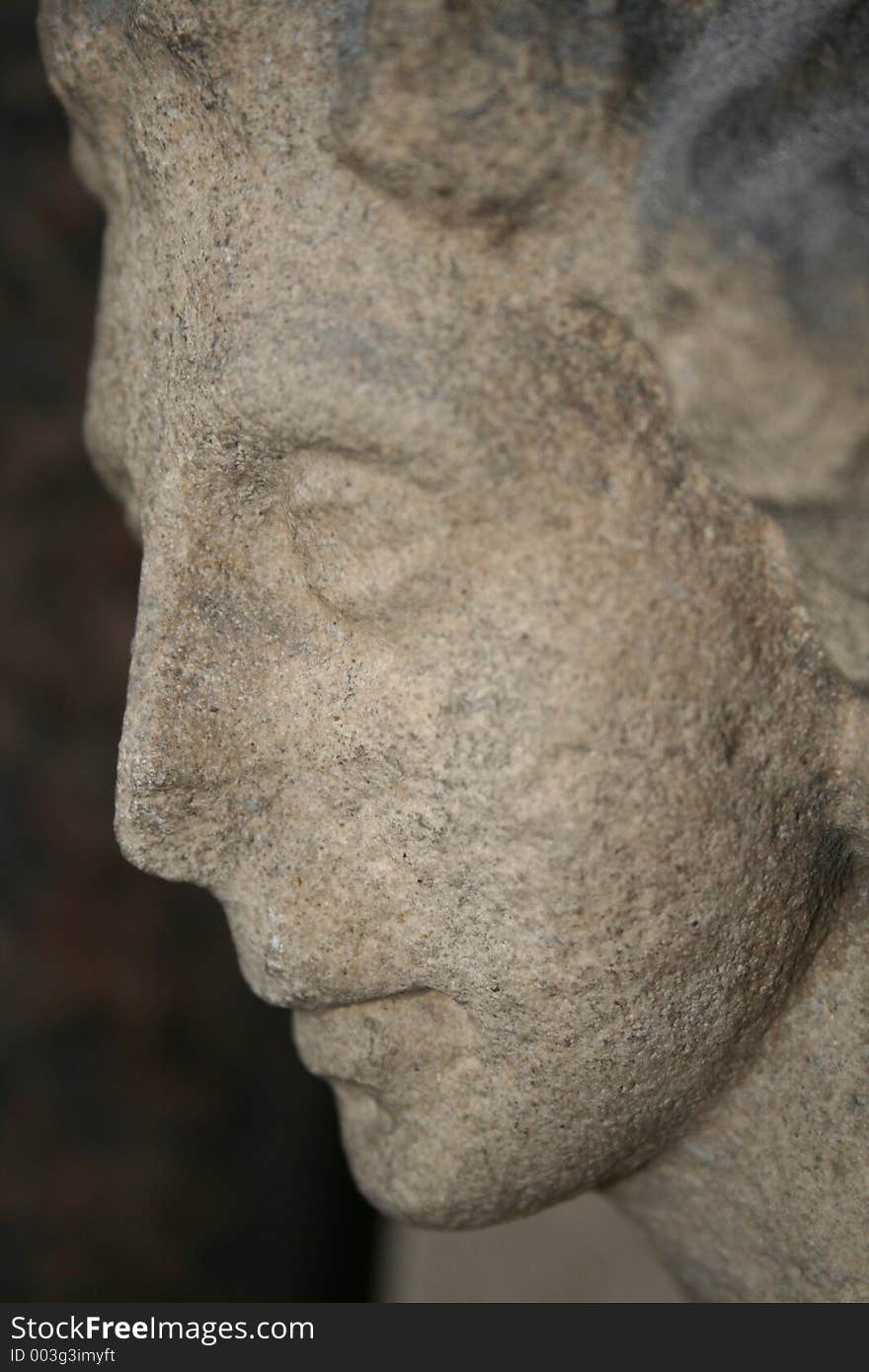 Close up image of a stone face on an old church in london