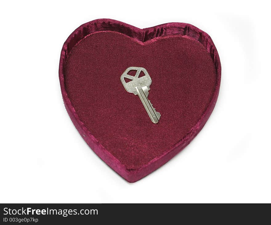 Silver key inside a heart box