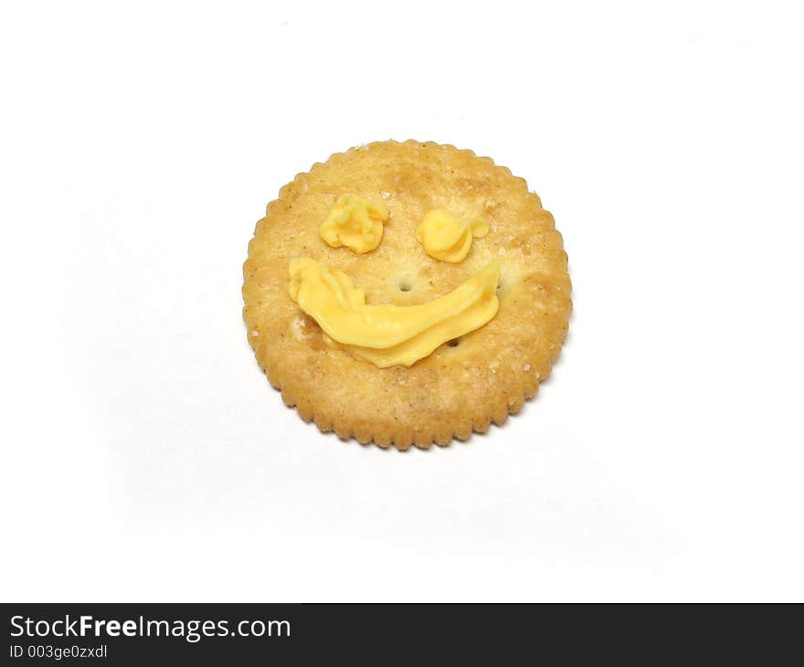 Close up of a snack cracker with a smiley face, isolated on white. Close up of a snack cracker with a smiley face, isolated on white
