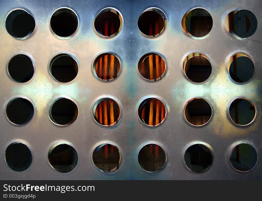 Close-up of sheet of metal with holes in urban building. Close-up of sheet of metal with holes in urban building