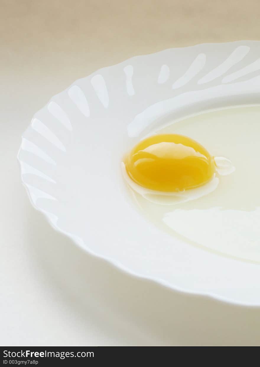 Still life with egg on white dish and white background. Still life with egg on white dish and white background