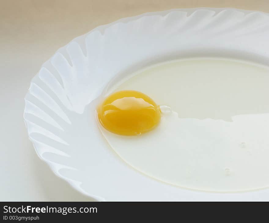 Still life with egg on white dish and white background. Still life with egg on white dish and white background