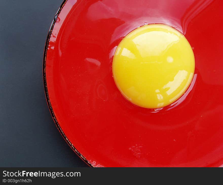 Still life with egg on red and black colours. Still life with egg on red and black colours